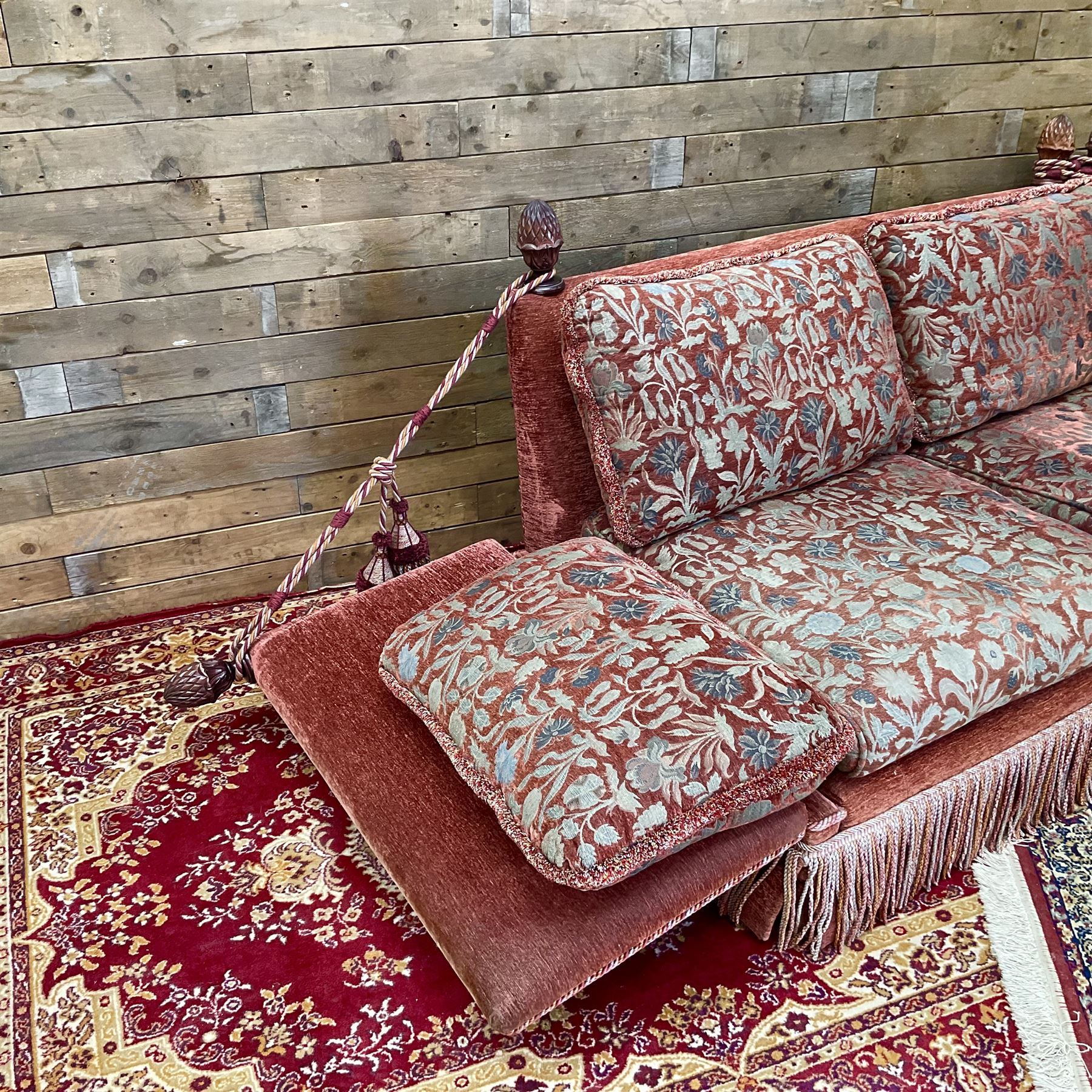Knole type drop arm sofa with cushions in a traditional patterned upholstery,
