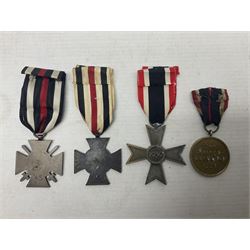 Two WW1 German medals - copy Cross of Honour with swords (combatants); Cross of Honour without swords (non-combatants); and two WW2 German medals - War Merit Medal; and War Merit Cross; all with ribbons (4)