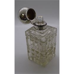Late Victorian silver mounted cut glass scent bottle, of square section form, the plain domed hinged silver cover lifting to reveal a glass stopper, hallmarked London 1897, makers mark worn and indistinct, H14.5cm