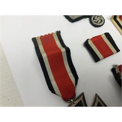 WWII German Iron Cross 2nd Class, the suspension ring stamped 128 for S. Jablonski G.m.b.H. Posen; with ribbon; together with an embroidered cloth eagle badge and quantity of German medal ribbons.