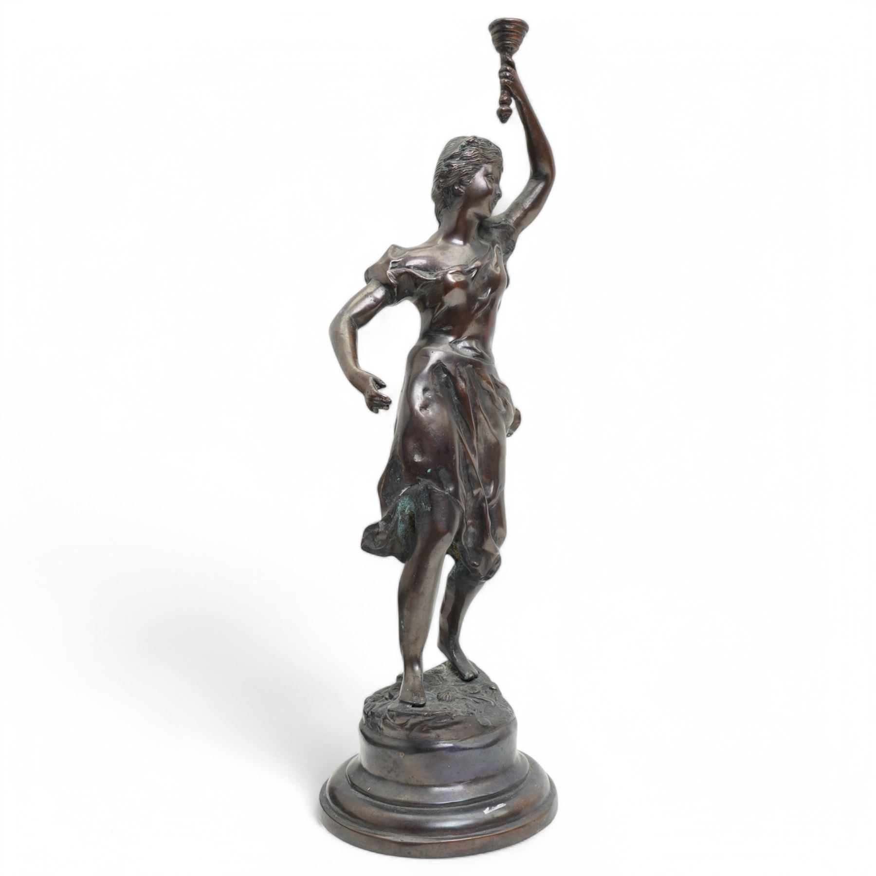 After Victor Rousseau (1865-1954)  - bronze sculpture of a lady holding aloft a torch and on circular base H50cm