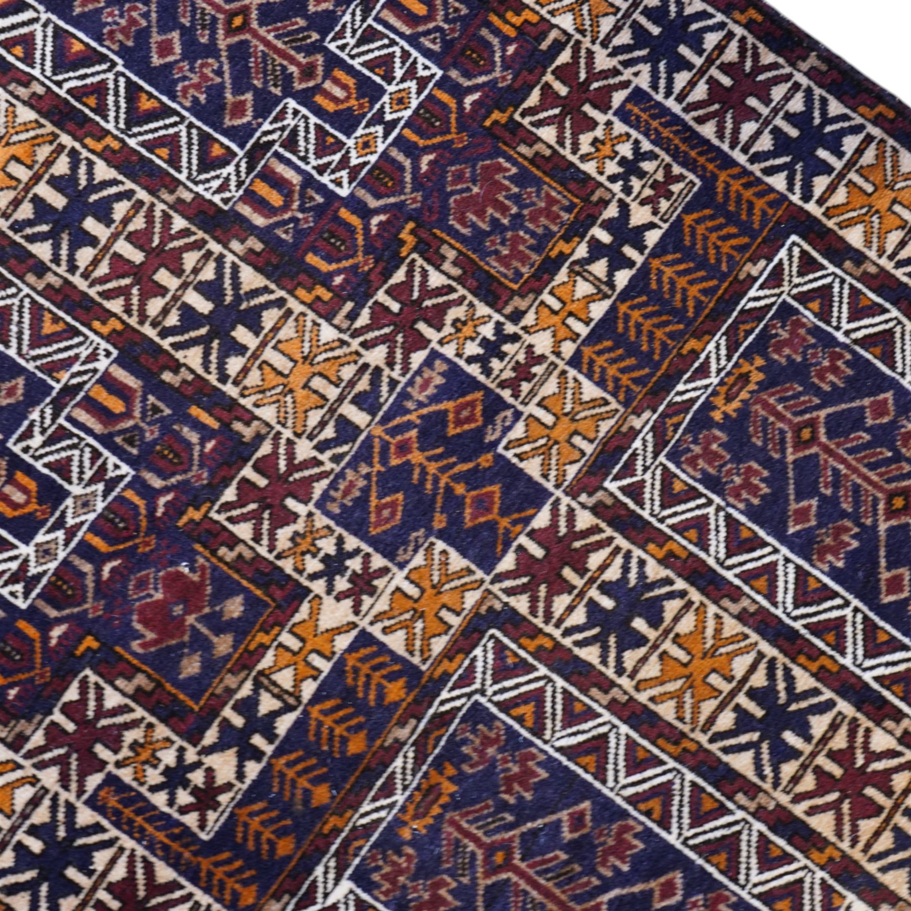 Persian Beluchi indigo ground prayer rug, overall geometric design (147cm x 85cm); together with a Bokhara rust ground rug (146cm x 101cm)