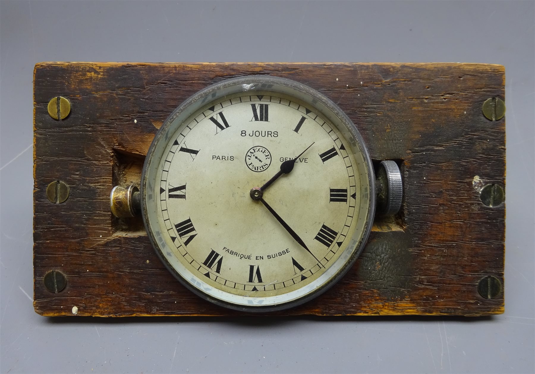 Jaeger aluminium eight day car clock, side wound, mounted on wooden