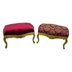 Pair of Louis XV-design giltwood stools, each upholstered in red damask fabric with slight variations in patterns, the carved frames adorned with scrolling foliage and shell motifs, raised on cabriole supports