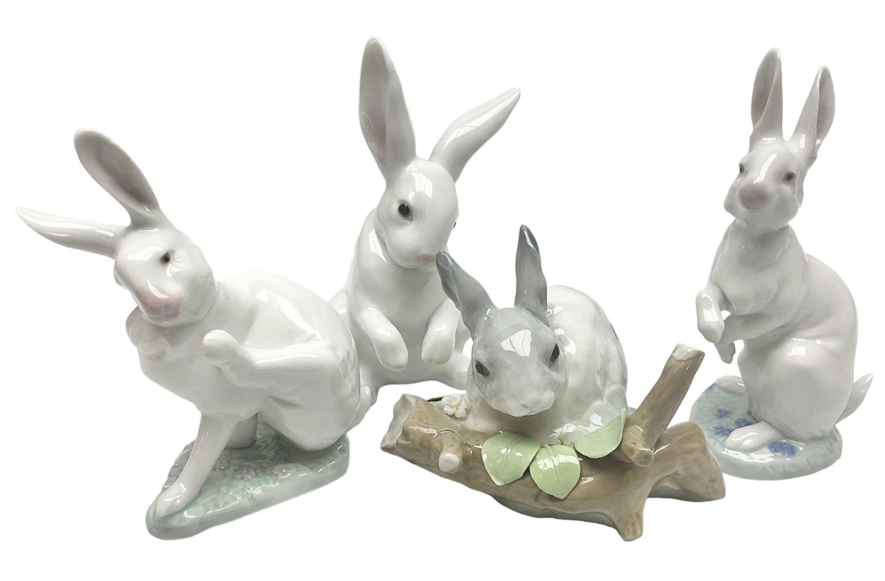 Four Lladro rabbit figures, comprising, Hippity Hop no 5886, Sitting Bunny no 5907, Washing up no 5887, and Rabbit Eating no 4773, largest example 14cm  