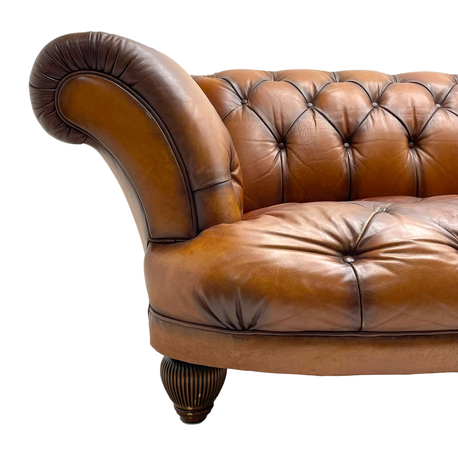 Tetrad - 'Oskar' grande three-seat sofa, Chesterfield shape with rolled arms, upholstered in buttoned tan leather, on turned and reed moulded feet 