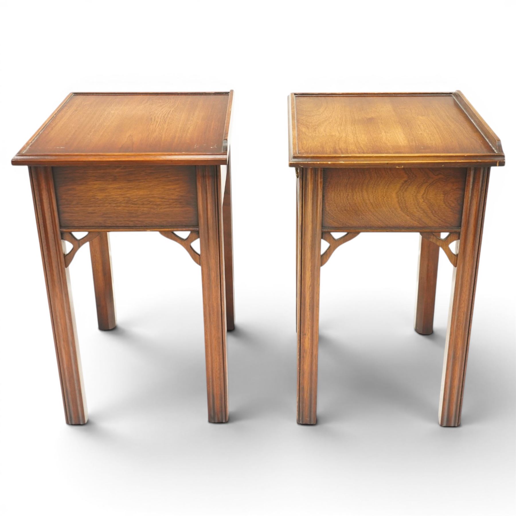 Pair of mahogany bedside tables, with quarter galleried top, single drawer with brass swan neck handle, pierced spandrels on fluted square supports  