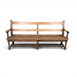 Early 20th century pine and oak bench seat, stained pine rail back frame with shaped oak arms