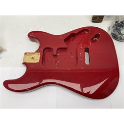 Disassembled Squier guitar and quantity of unused Fender guitar parts