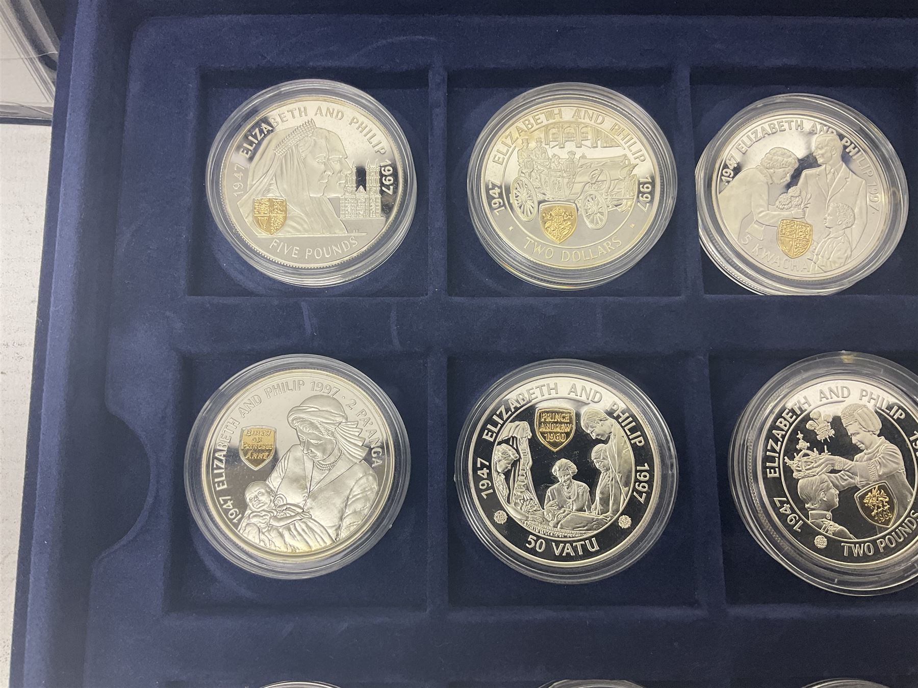 The Royal Mint Golden Wedding Anniversary silver proof coin collection, comprising twenty-four international commemorative coins, cased with certificates