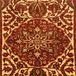 Persian Kerman hand-knotted rug, ivory and crimson ground, central medallion surrounded  by a floral foliate pattern, main border with repeating design of floral cartouches and palmettes, and narrow vine work guard border  