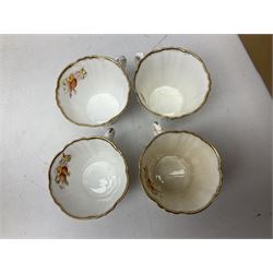 Quantity of Royal Albert tea wares to include 'Moss Rose' teapot, sucrier and saucers, together with teacups, saucers, side plates, jug etc decorated with orange, yellow and blue floral sprays with gilding upon plain ground, all stamped Royal Albert beneath