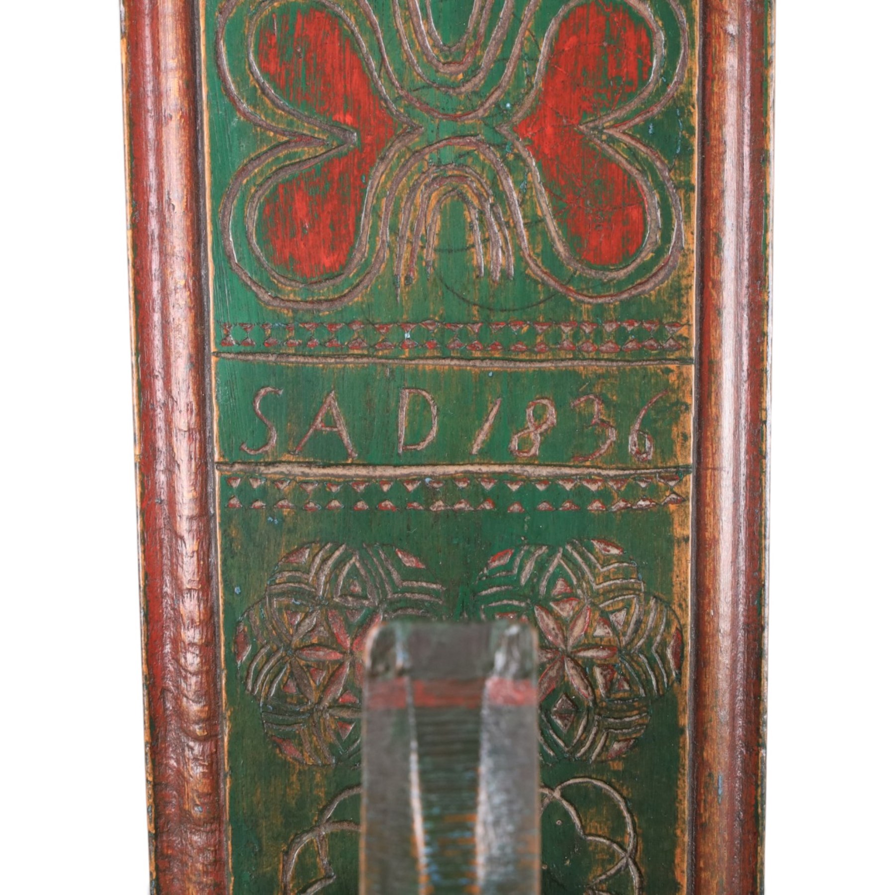 Mid 19th century Norwegian carved mangle board, dated 1836, of rectangular form with carved dala horse handle, with geometic red floral carvings upon a green ground, L63cm