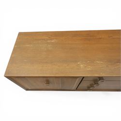 Ensign - Mid-20th century elm sideboard, with a central bank of four drawers, flanked by cupboard doors, raised on tapering supports, labelled Ensign Bristow & Townsend Ltd