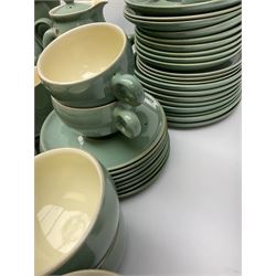 Denby Manor Green pattern tea service, comprising of three teapots, twelve coffee pots of various sizes, four hot water jugs with lids, seven jugs, eleven teacups, four mugs, seventeen saucers, six sugar bowls, two sugar bowls with lids and eleven side plates.  