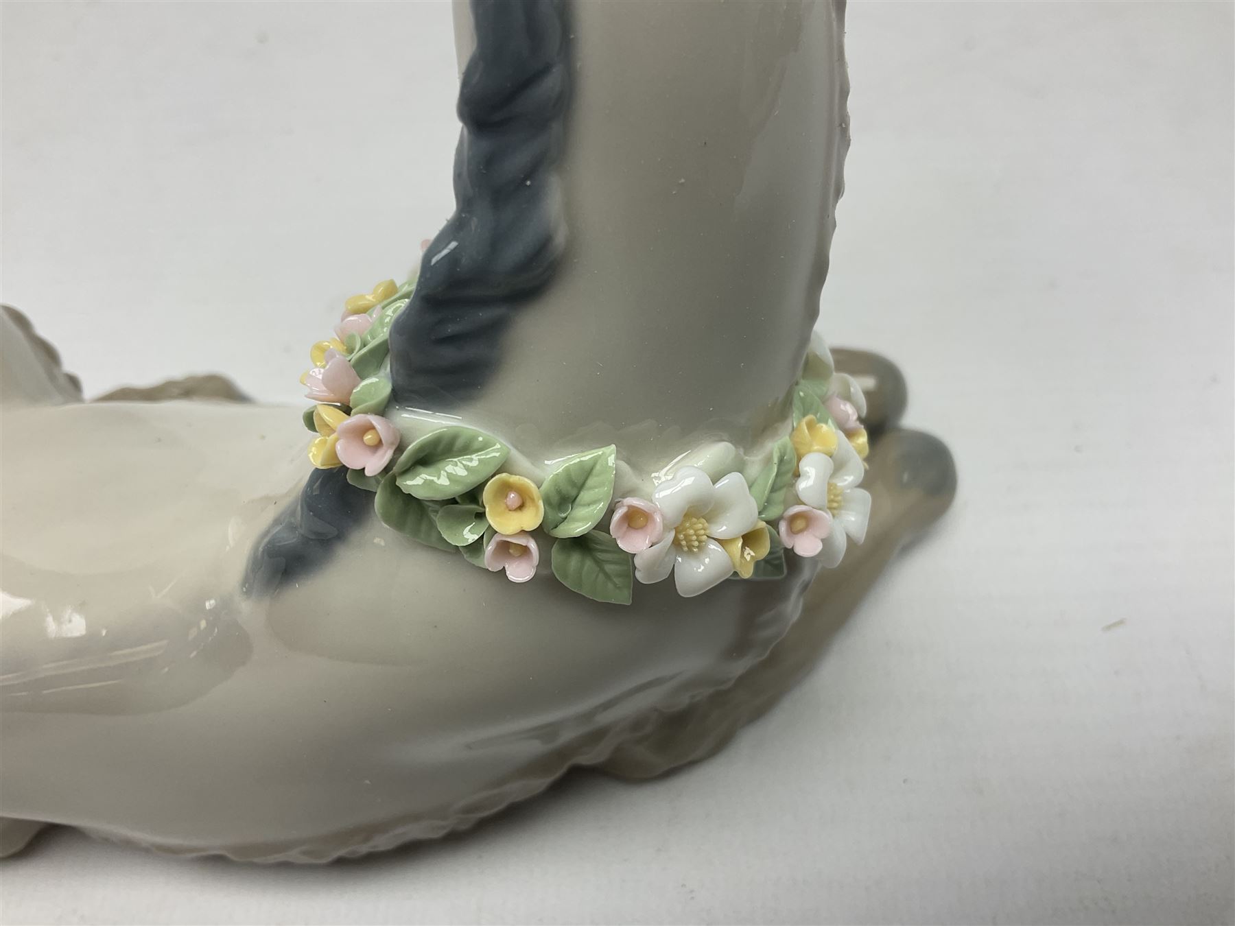 Lladro figures of animals, comprising Mini Lion no 5436, Beautiful Burro no 5683, Hawk Owl no 5422, Beagle Puppy Sitting no 1071, Duck Flying no 1264, Miniature Cat no 5308 and Small Papillon Dog no 4749, four with original boxes, largest example H14cm