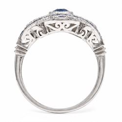 Platinum sapphire and diamond dress ring, milgrain set with a single oval cut sapphire, surrounded by single cut diamonds, calibre and vari-cut sapphires, in an pierced design setting, stamped PT 950, total sapphire weight 0.87 carat, total diamond weight 0.45 carat