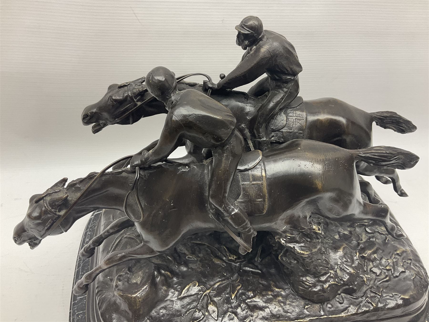 After E Loiscay, bronzed figure group, modelled as two race horses, signed E Loiscay, upon a stepped marble plinth, overall H28cm