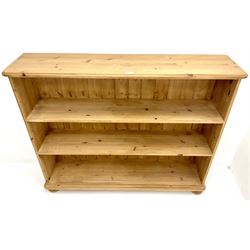 Solid pine open bookcase, moulded top, two shelves, bun feet