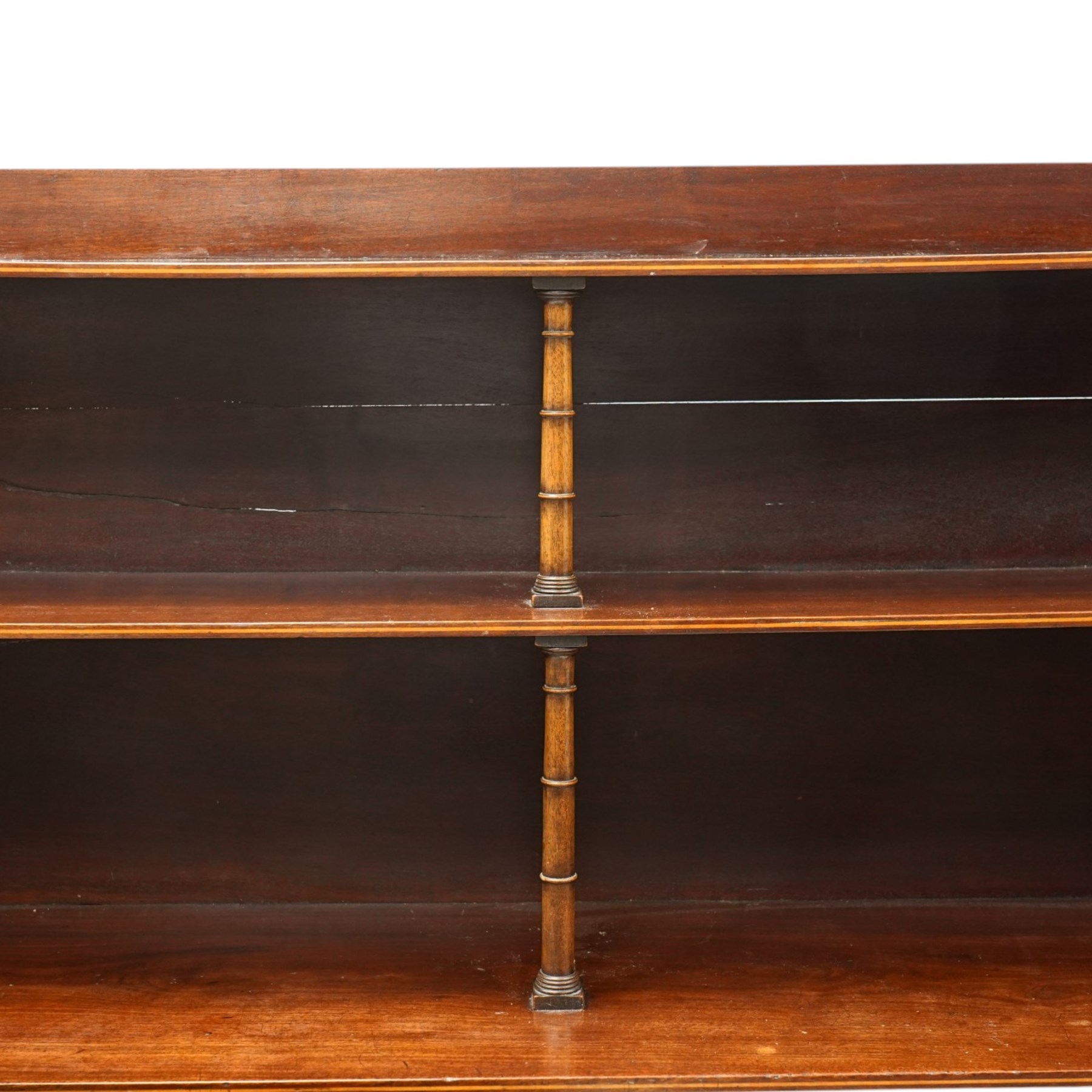 Regency period mahogany waterfall-bookcase chiffonier, the raised back with two open shelves supported by central ring-turned pilasters, fitted with twin doors with sage-green pleated fabric facias, over two drawers with satinwood stringing, raised on front sabre supports