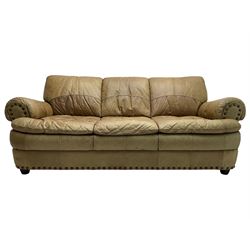 Large three-seat sofa upholstered in stitched brown leather with stud work decoration, rolled back and arms