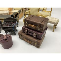 Collection of miniature dolls house furniture, to include mirrored fireplace unit with bookcases and cupboards to either side, painted white with gilt detail and yellow flowers, three piece peach chaise lounge and chair set, Knoll style sofa, display cabinets, footstools, suitcases, etc (25)