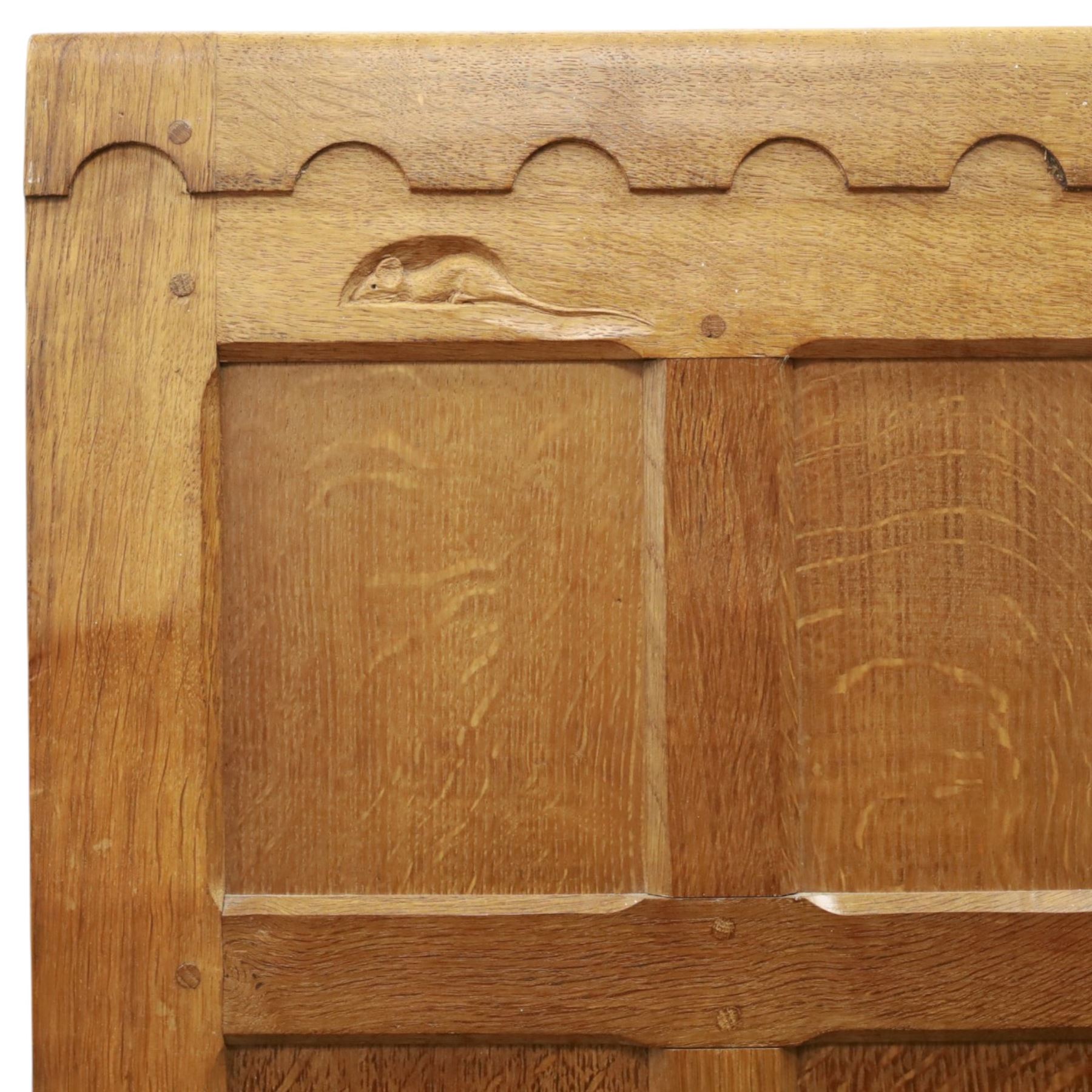 Mouseman - early-to-mid-20th century panelled and adzed double wardrobe, the arcade carved cresting rail over two panelled doors, with wrought metal hinges and latch, deep relief carved mouse signature, the interior fitted with hanging rail, by the workshop of Robert Thompson of Kilburn