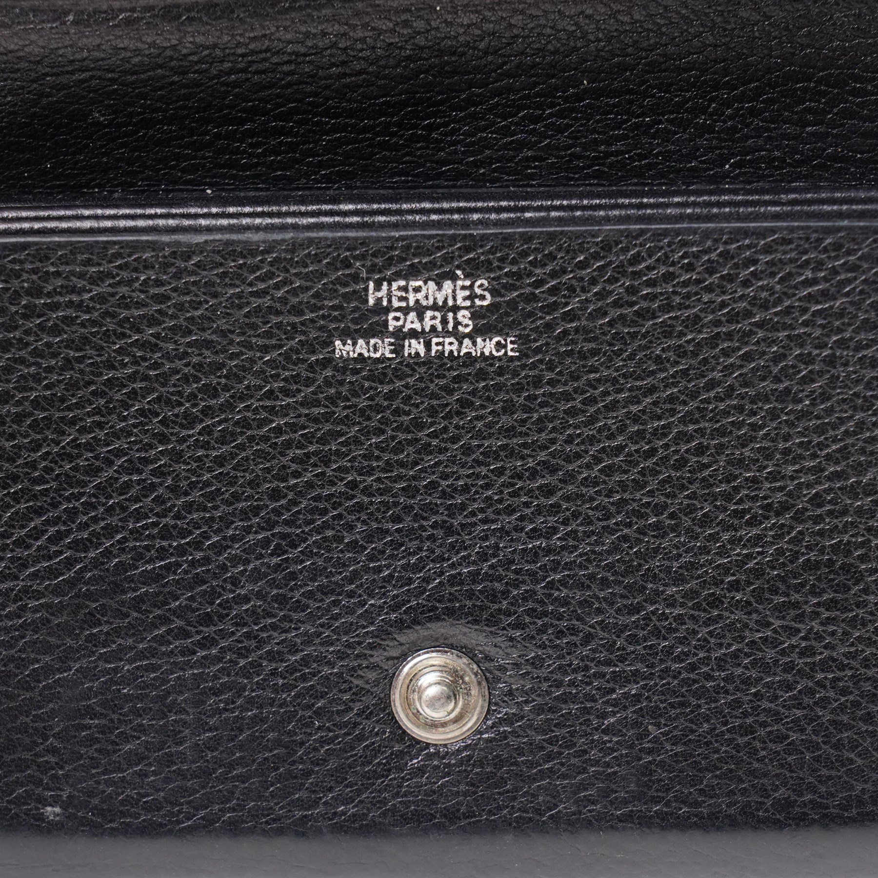 Hermès - black grained leather gusseted card holder, with press-stud fastening and concertina interior, stamped Hermès Paris Made in France, with original box