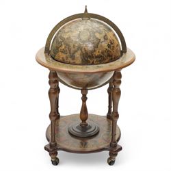 20th century Italian design drinks globe, the hinged celestial printed sphere enclosing a fitted bottle and glass compartment, circular base decorated with zodiac signs and mounted on turned supports with castors