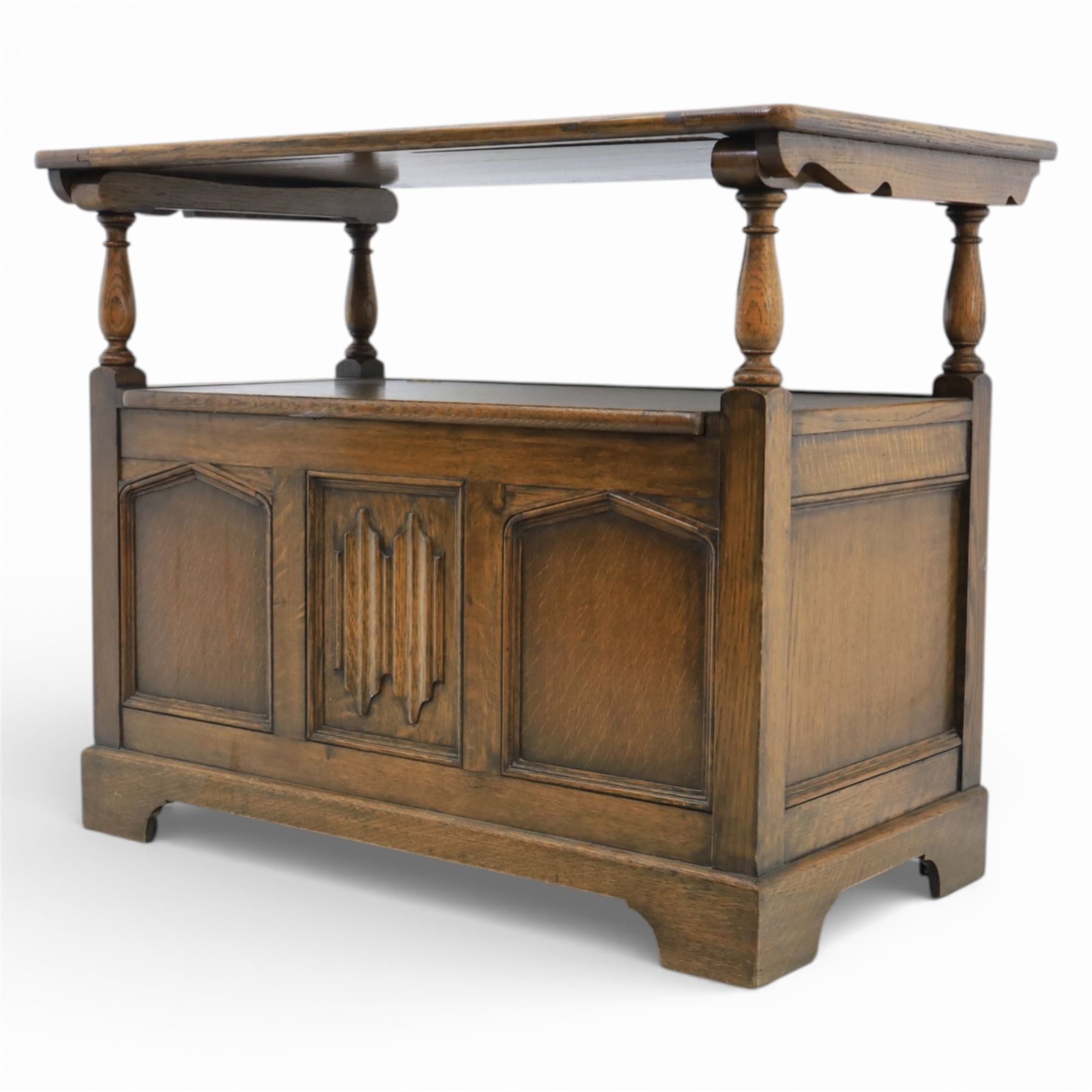 20th century oak monks bench with hinged box seat, with blind fretwork to the seat, panelled front and sides with linen fold panel in the centre