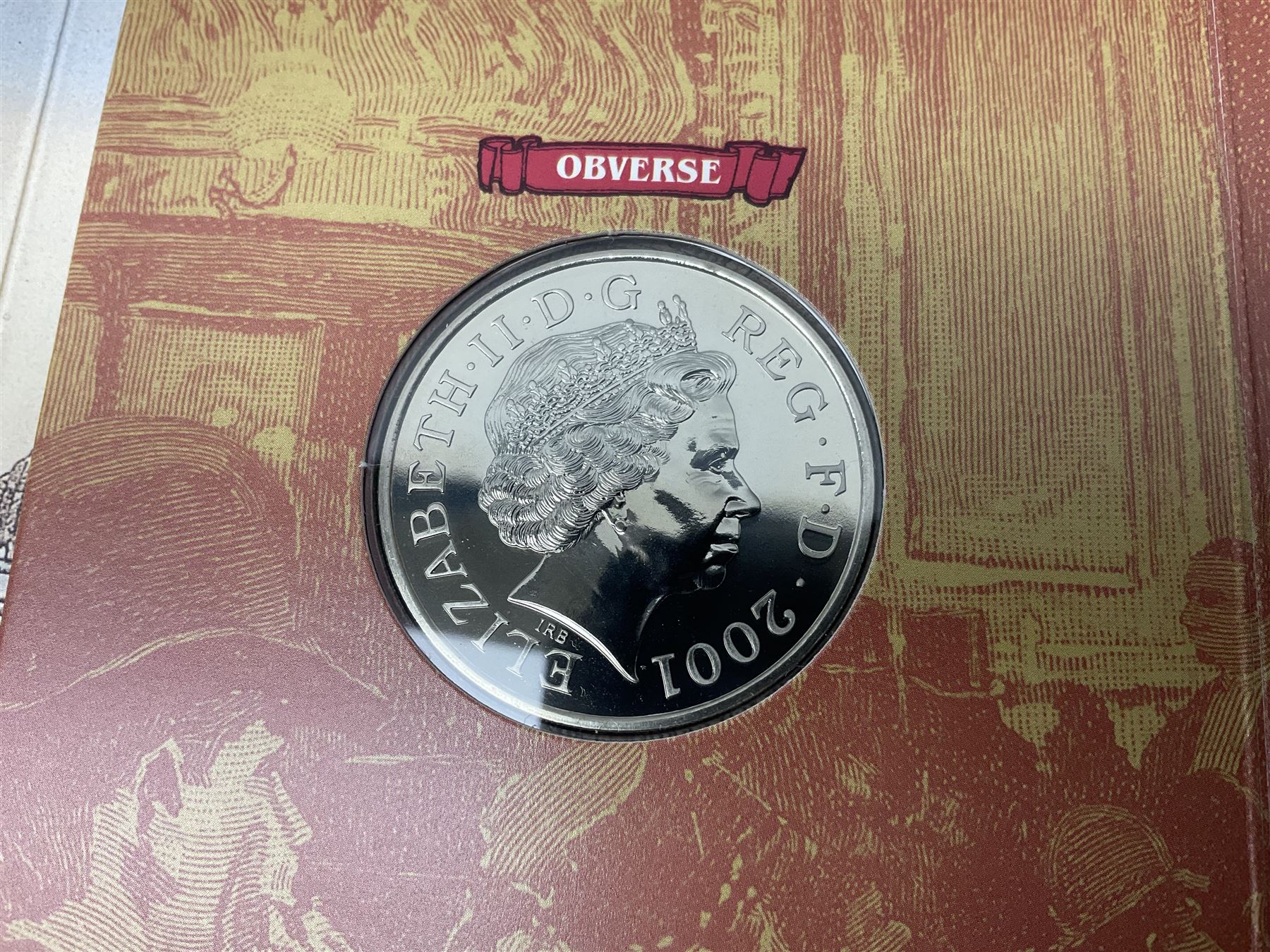 The Royal Mint United Kingdom 1984 brilliant uncirculated coin collection, 1997 and 2001 commemorative crown coins, 1997 old round one pound, all in card folders and four sterling silver medallic first day covers from the 'Great Britons' collection housed in a blue folder