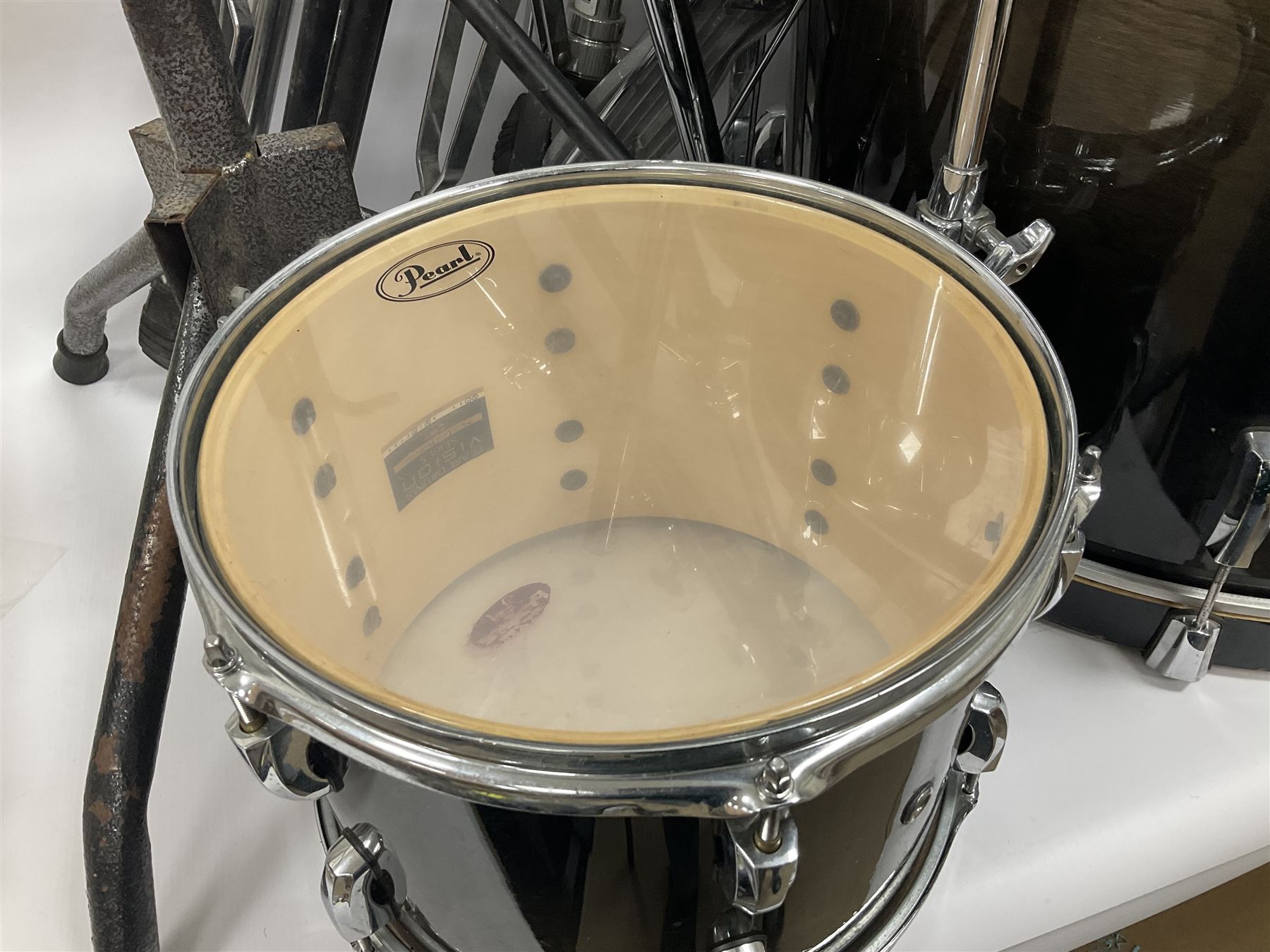 Pearl Vision SST Birch Ply shell four-piece drum kit in black comprising bass drum with foot pedal and three graduated toms; together with Pearl Custom Alloy Sensitone steel snare drum, drum and cymbal stands, microphone stand, stool and various drum sticks 