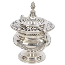 Early 20th century silver twin handled lidded bowl, of circular form with C scroll handles, the body embossed with floral swags, the pierced lid with pineapple finial, hallmarked Horace Woodward & Co Ltd, London 1911, H16cm