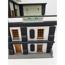 1:24 scale four-storey tudor-style dolls house, with black and white exterior, balcony garden, glazed panelled windows and wooden shingle roof, with decorated interior and wired fireplaces and lighting, H65cm, W58cm, D31cm, 