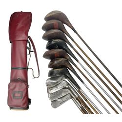 Approximately twenty-three golf clubs, to include early 20th century examples, Spalding Bruce Devlin Gold Line Ply Power and Kro-Flite wood examples, mallet head examples, putters etc, together with carry case