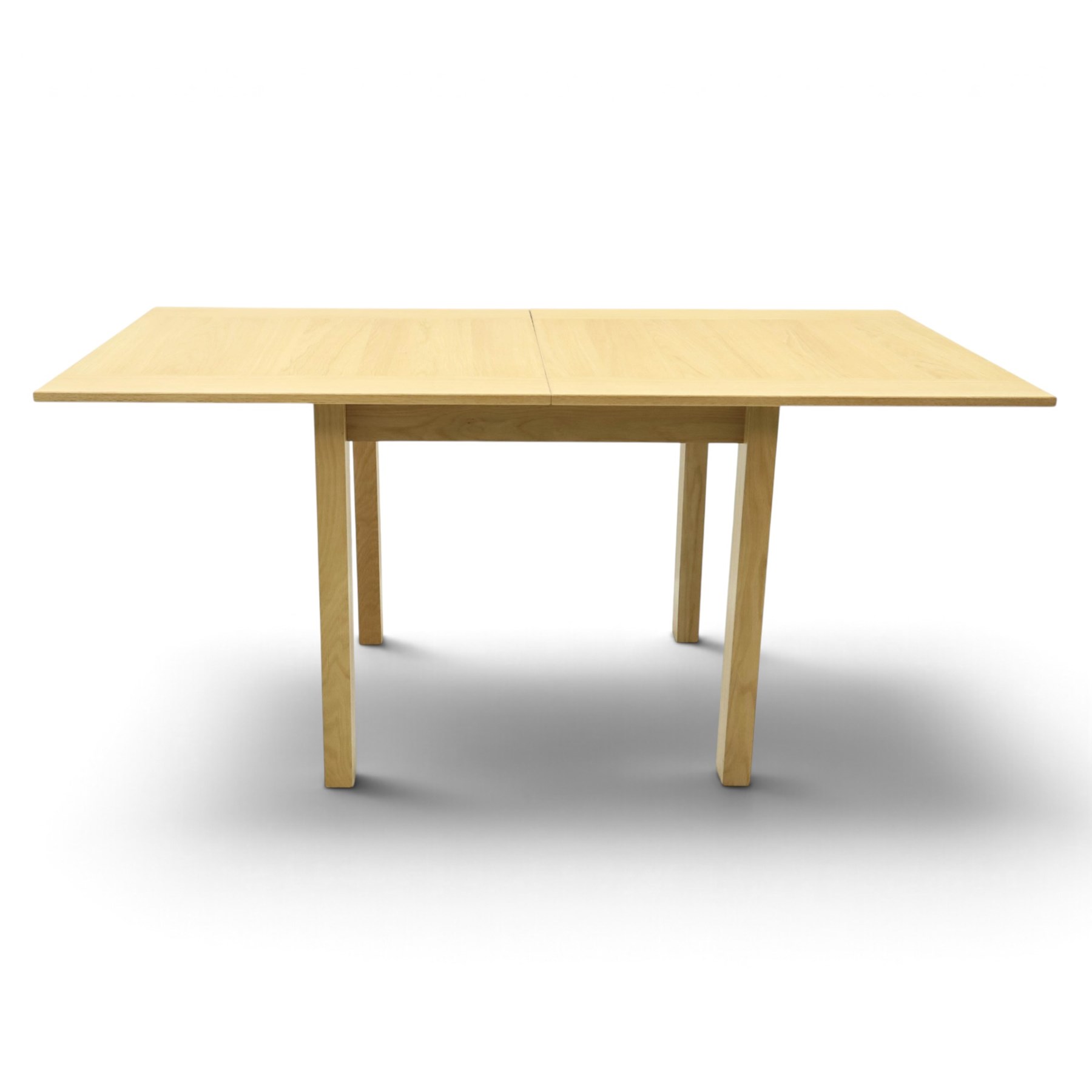 Contemporary light oak extending dining table, the square top with pull-out and fold-over action, raised on square supports