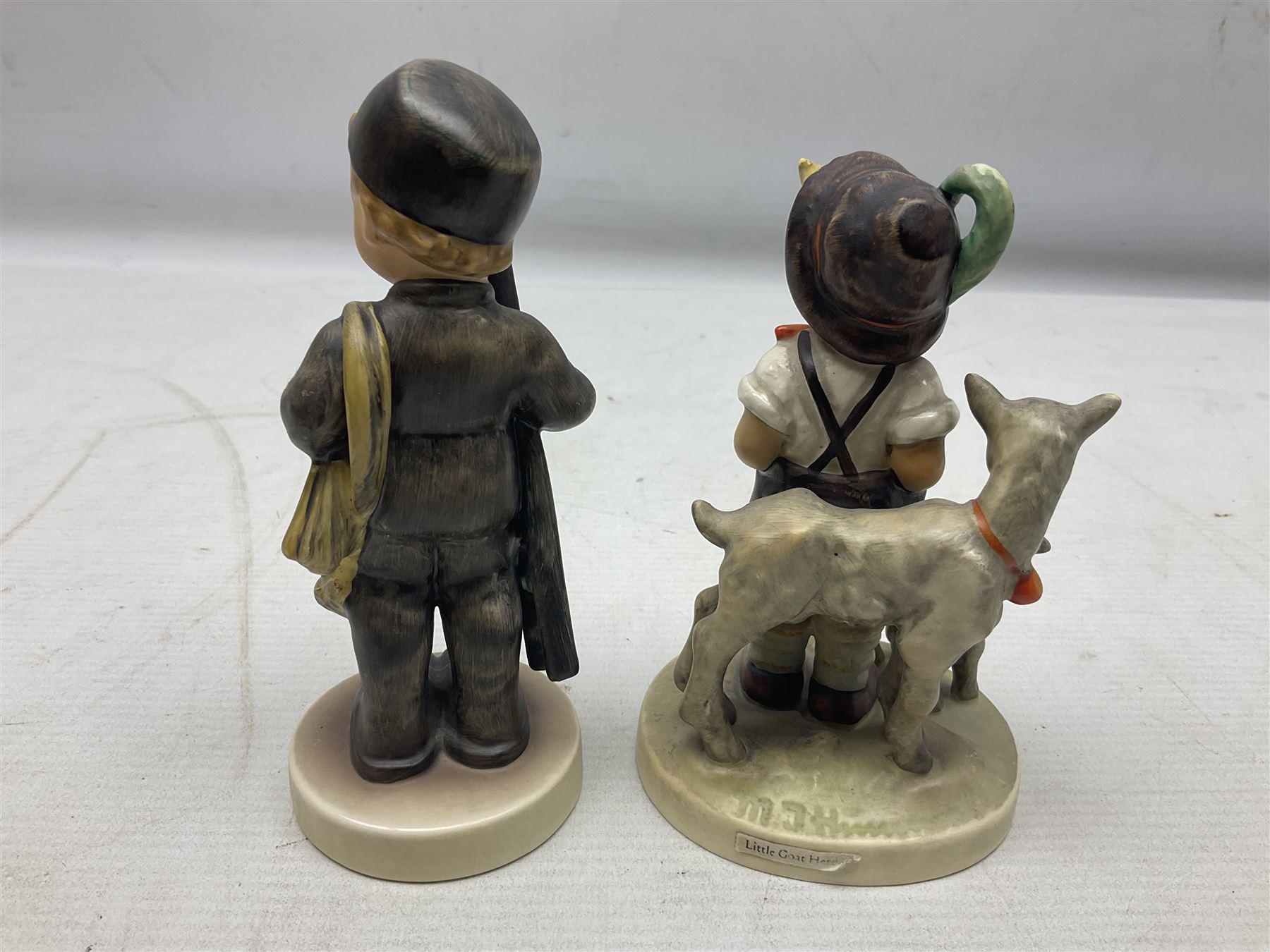 Seven Goebel Hummel figures, comprising Chimney Sweep 12/I, Apple Tree Girl 14/I, Apple Tree Boy,  Little Goat Herder 200/I, Surprise 94 3/0, Signs of Spring 203/20 and Wayside Harmony 111/30, tallest H15cm