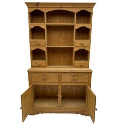 Solid pine dresser, raised plate rack fitted with small drawers over two drawers and double cupboard, plinth base