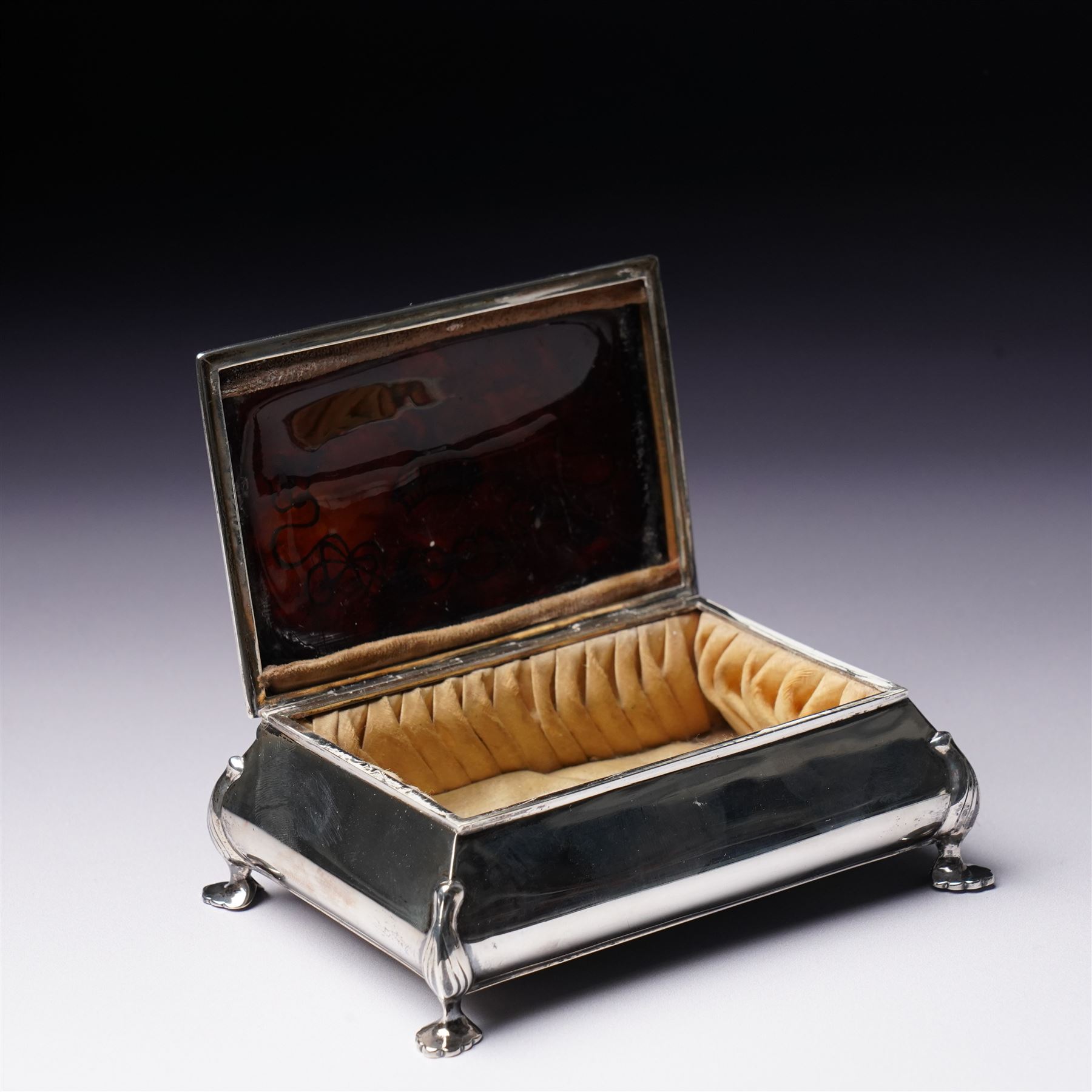 Edwardian silver rectangular trinket box with padded interior, the hinged cover inset with a tortoiseshell panel with pique decoration and on shaped supports W12cm Birmingham 1910 Maker Henry Matthews