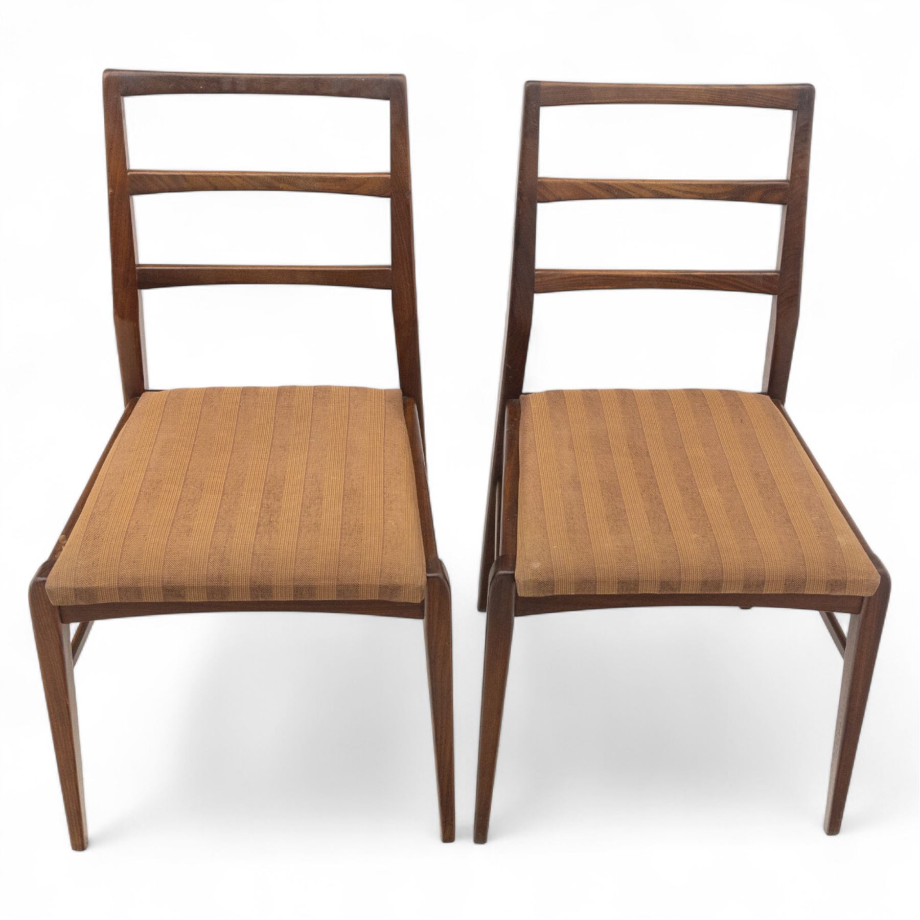 Richard Hornby for Fyne Ladye - mid-20th century afromosia teak dining table, tapered rectangular top with fluted edge and recess for spare leaf, raised on slender legs, four teak framed chairs, of ladder back design, with drop-in seat, upholstered seat, with tapered front legs and slightly raked rear legs,, table unextended width 106cm depth 79cm height 74cm with additional leaf 45cm wide- chairs width 48cm depth 41cm height 87cm 