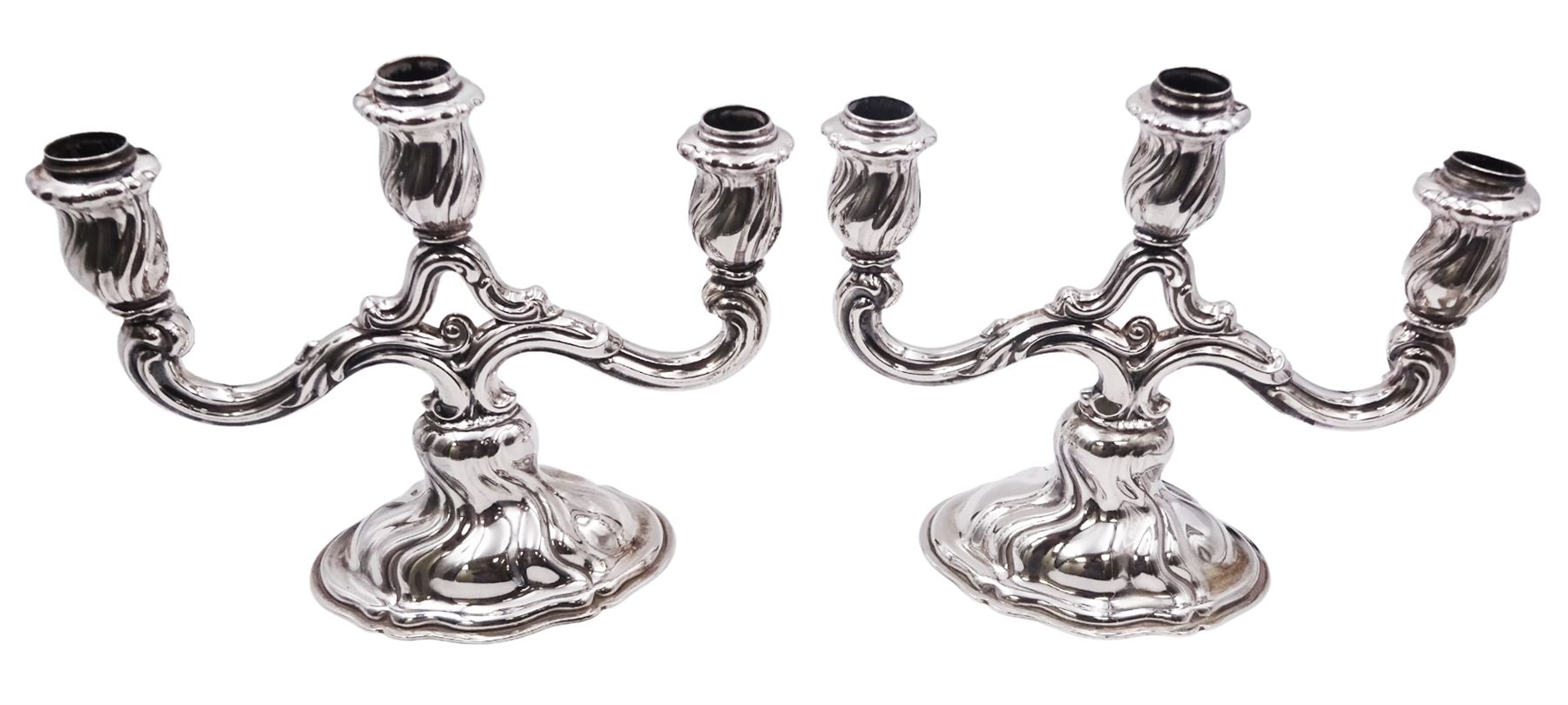Pair of 20th century German silver three light twin branch candelabra, with wrythen twist detail throughout, each with crown and crescent mark, stamped 835 and bearing mark for Bruckmann & Sohne, Heilbronn, H21cm W25cm