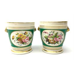 A pair of cache pots, hand painted with oval floral panels and heightened with gilt, with twin lion mask 'handle' detail, H13.5cm. 