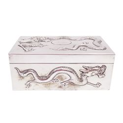 Late 19th century/early 20th century Chinese export silver mounted cigarette box, of rectangular form, decorated in relief with dragons, the hinged cover with similar dragon decoration and central blank oval cartouche, opening to reveal a softwood lined compartmentalised interior, stamped beneath with character mark and KMS for maker Kwong Man Shing, H6.3cm, W15.5cm, D9.5cm