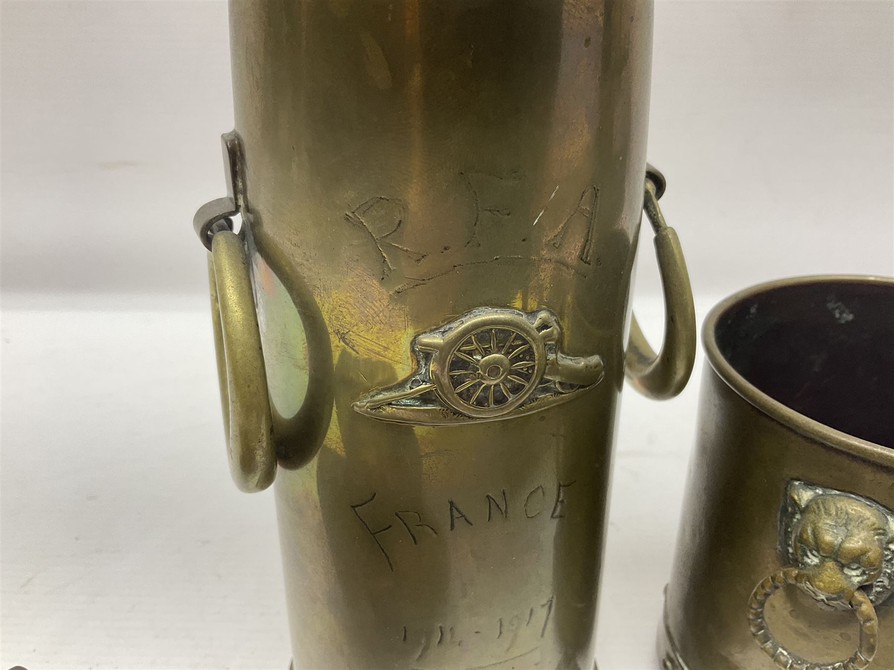 Trench Art - WWI 0-8-0 steam locomotive made from brass, copper and late Victorian pennies and half-pennies L17.5cm; WWI brass and copper tank candleholder; WWI brass shell case two-handled vase inscribed 'RFA France 1914-17'; and an unrelated brass plant holder (4)
