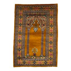 Angle-poise lamp and an Islamic prayer mat