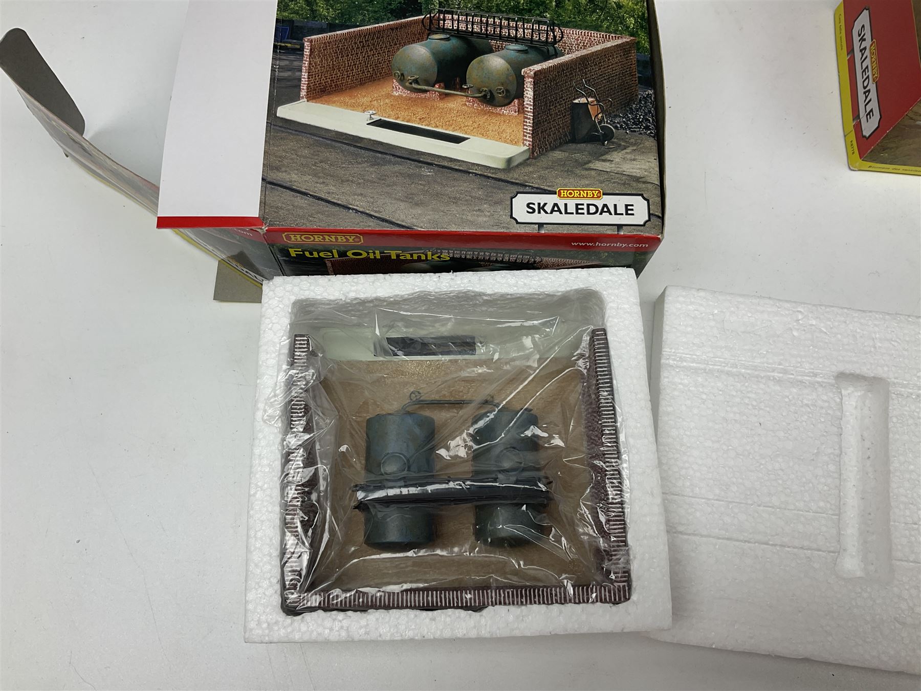 Hornby '00' gauge - thirteen Skaledale trackside buildings/accessories including R8737 Small Gasholder, R9653 Baptist Church, R8542 Holly Farm Workshop, R8534 Signal Box, R8854 Fan Drift, R8525 Holly Farm Stables, R9531 Magna Waiting Room, R8778 Fan House, R8709 Fuel oil Tanks etc; all boxed (13)
