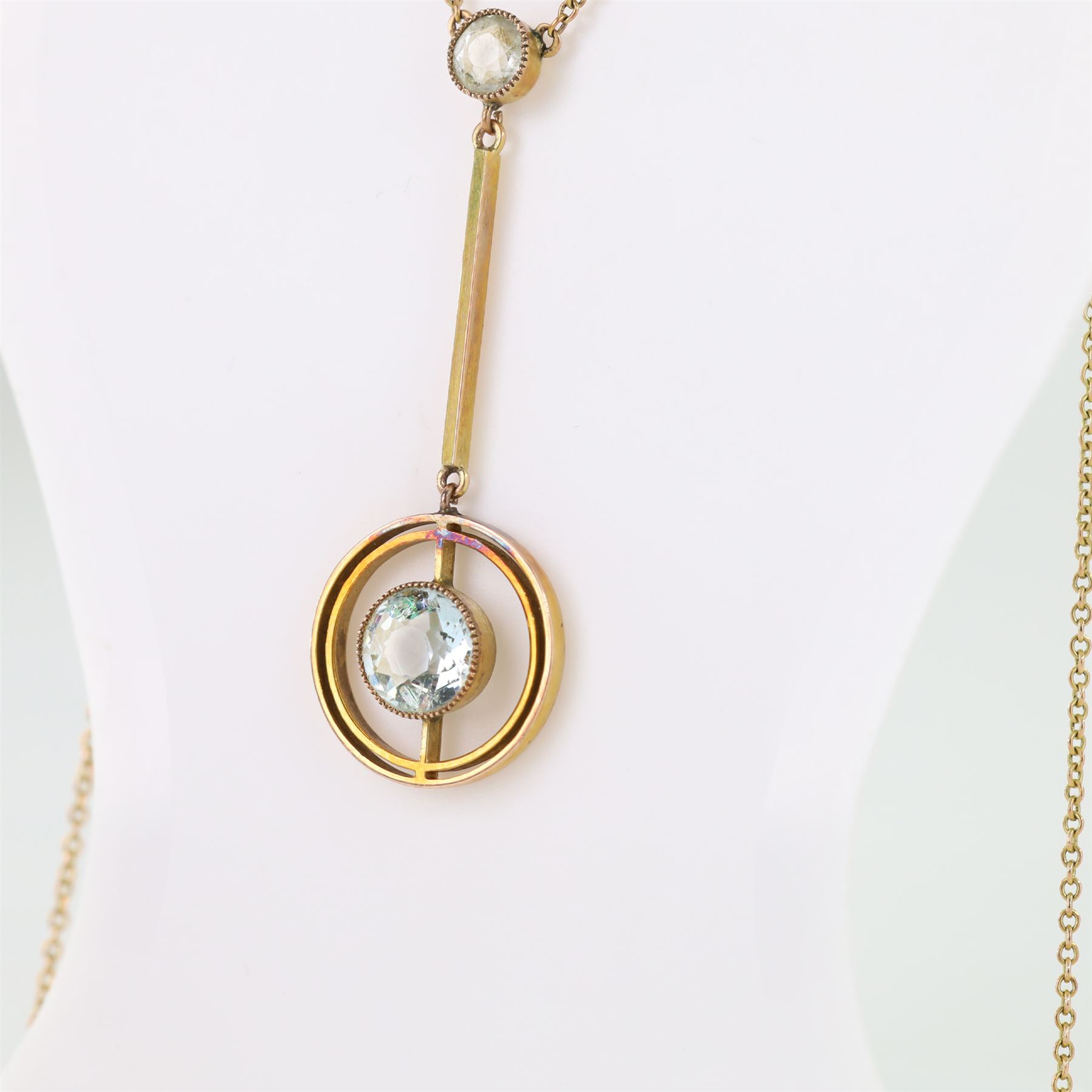 Early 20th century gold aquamarine pendant necklace, milgrain set round cut aquamarine within a pierced circular setting, to a smaller round cut aquamarine, on a fine trace link chain necklace, stamped 9ct, in a velvet and silk lined box by Leefe & Sons, Malton