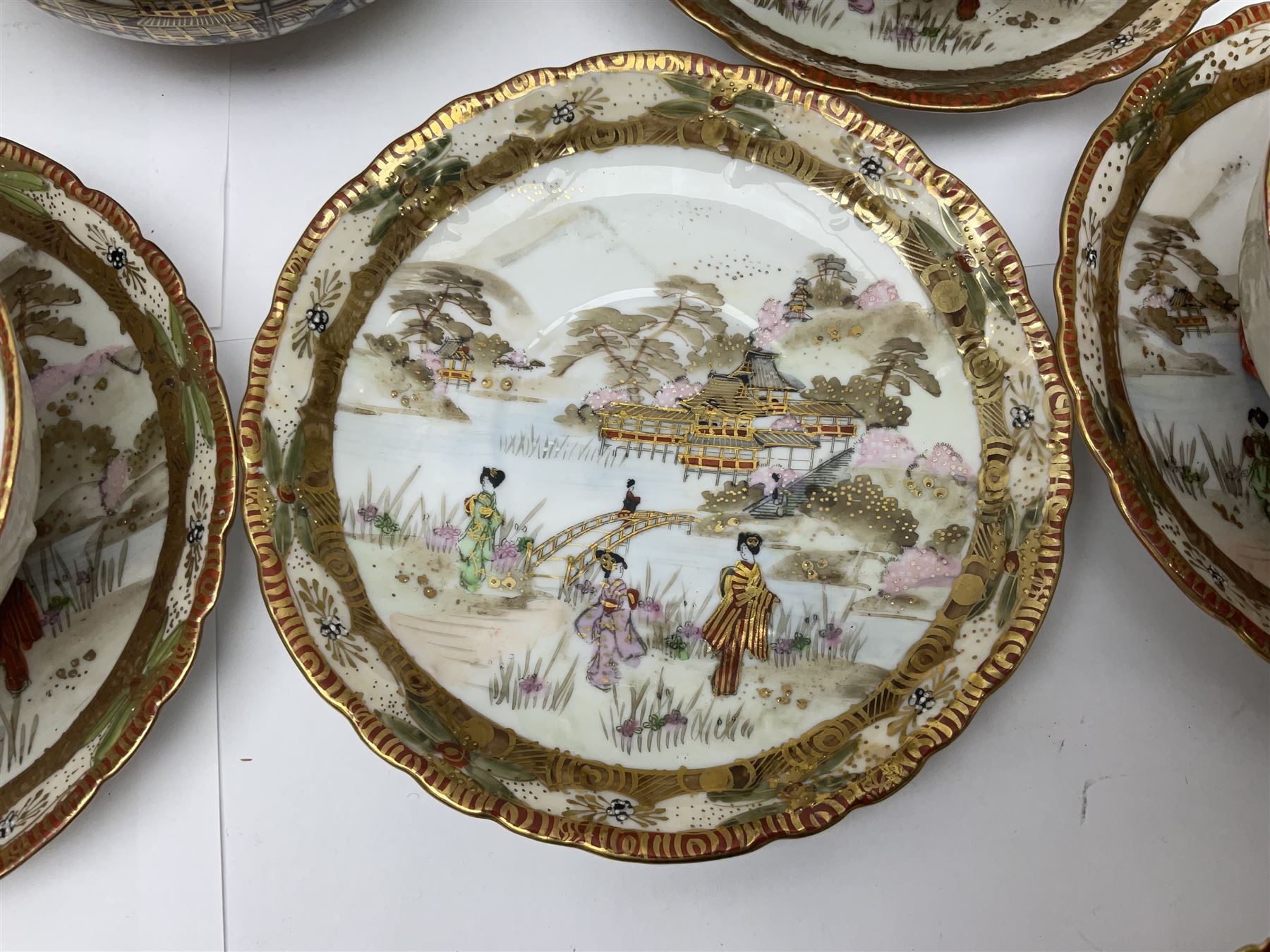 Noritake part tea service, printed and painted with figures in a landscape, comprising ten  tea cups and saucers, ten dessert plates, milk jug and sugar bowl