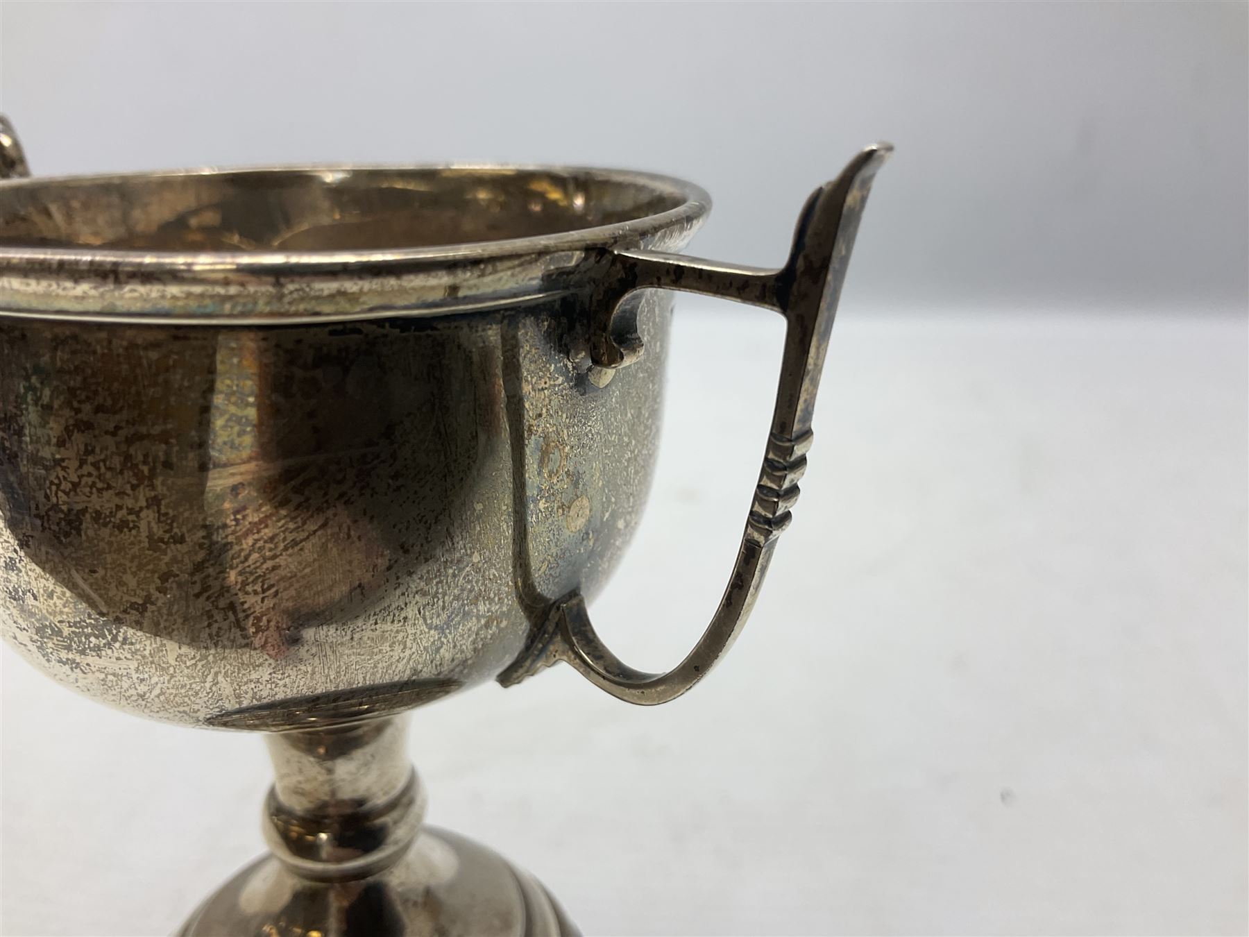 1930's silver twin handled trophy cup, upon black circular plinth, hallmarked Birmingham 1936, approximate silver weight 47 grams