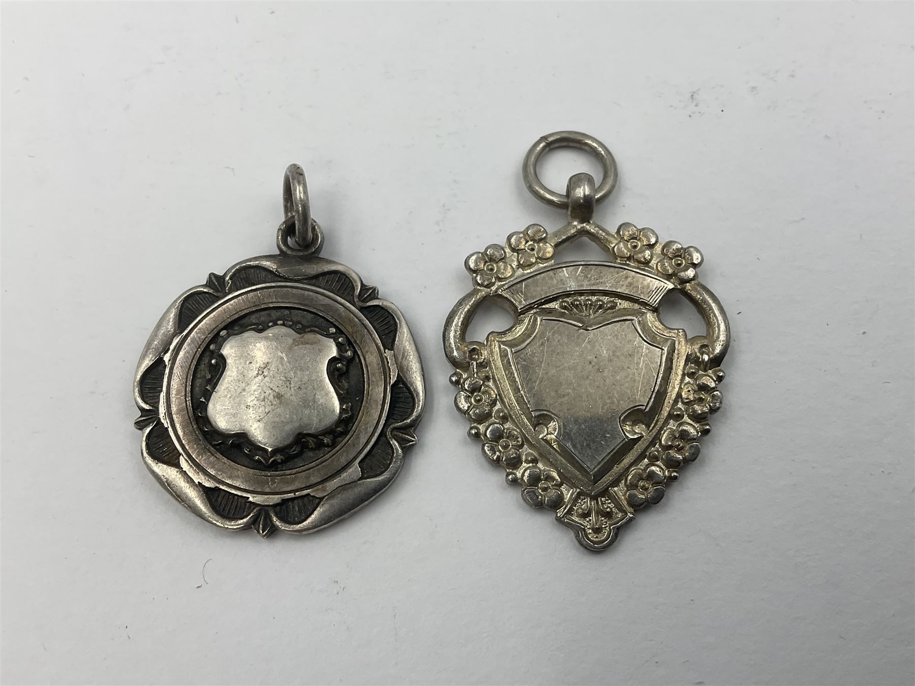 Ten early 20th century silver cartouche fobs, to include a Yorkshire Rose example, all hallmarked with various dates and makers
